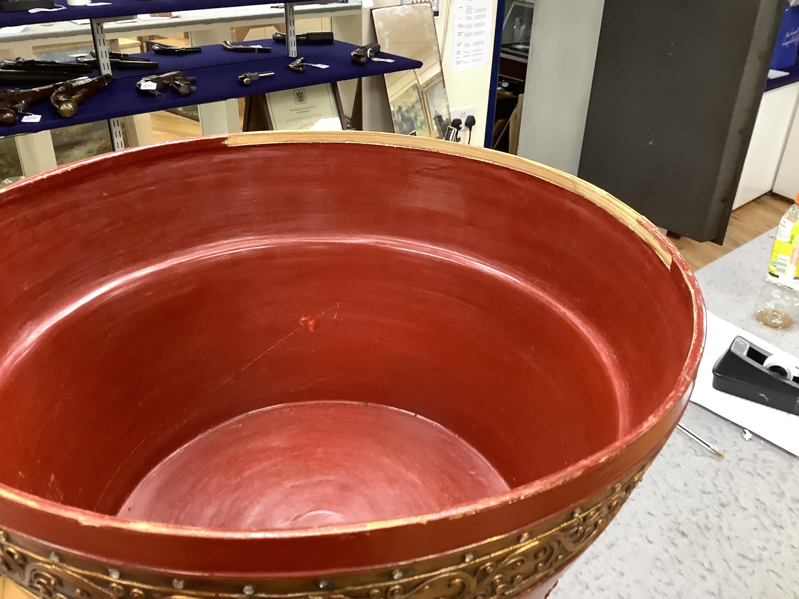 A South East Asian composition red lacquered table inset mirrored sequins, 44cm high x 51cm in diameter